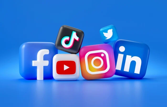 A group of social media logos, including Facebook, Instagram, LinkedIn, TikTok, Twitter, and YouTube on a blue background representing a successful social media strategy to drive business results.